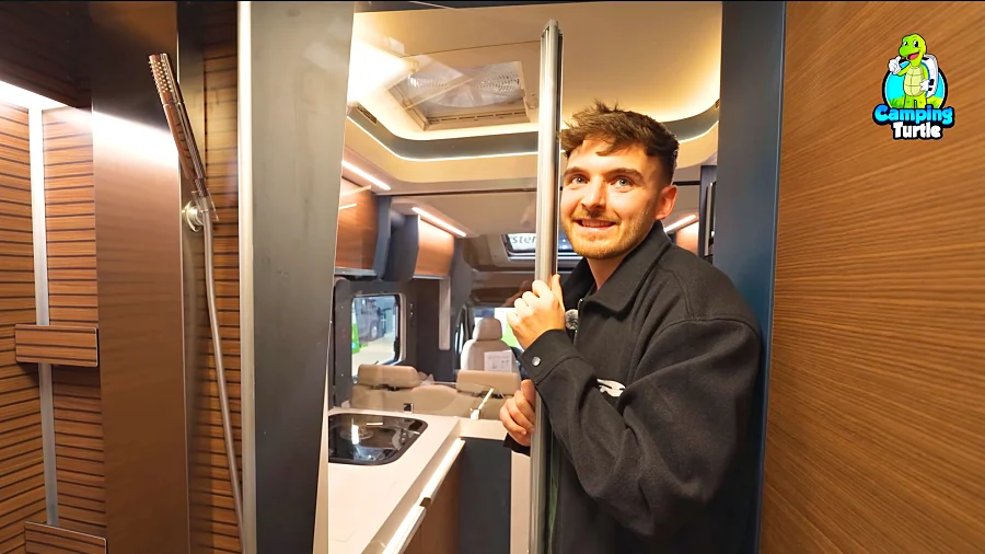 Marcel Carli in der Dusche, im Hintergrund Küche und Wohnraum