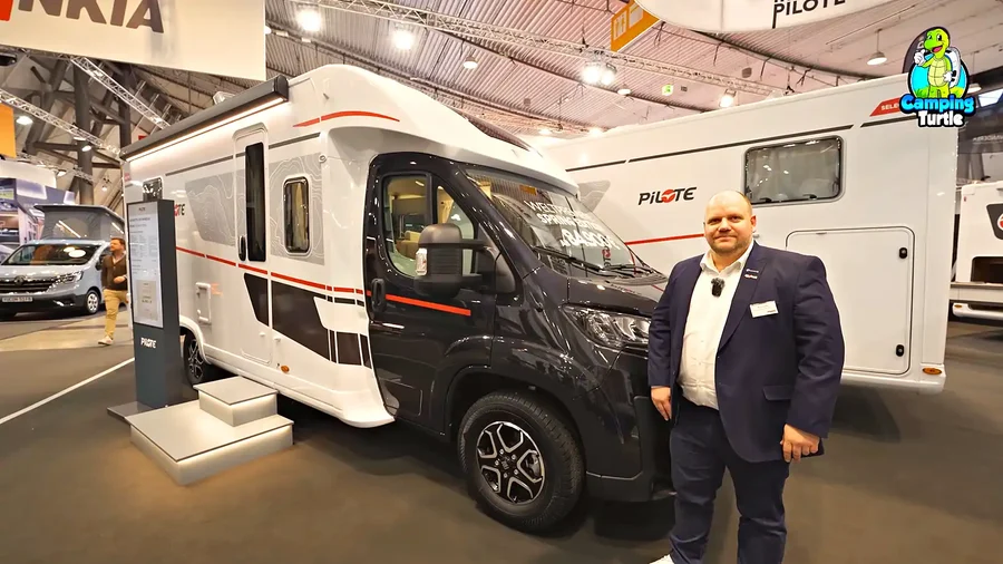 Marco Sander von Reisemobile Hillebrand vor dem Pilote P720FC Spring Edition mit schwarzem Fahrerhaus auf der CMT
